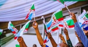 APC-members-holding-party-flag-1200×675-1-696×375