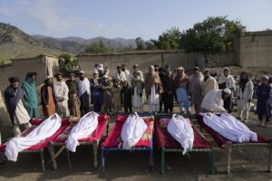 Men stand around the bodies of people killed in an earthquake in Gayan village, in Paktika province, Afghanistan, Thursday, June 23, 2022. A powerful earthquake struck a rugged, mountainous region of eastern Afghanistan early Wednesday, flattening stone and mud-brick homes in the country’s deadliest quake in two decades, the state-run news agency reported. (AP Photo/Ebrahim Nooroozi)