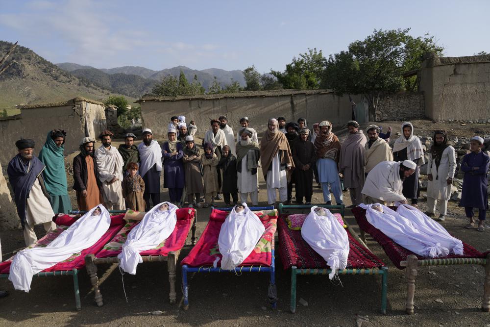 Men stand around the bodies of people killed in an earthquake in Gayan village, in Paktika province, Afghanistan, Thursday, June 23, 2022. A powerful earthquake struck a rugged, mountainous region of eastern Afghanistan early Wednesday, flattening stone and mud-brick homes in the country’s deadliest quake in two decades, the state-run news agency reported. (AP Photo/Ebrahim Nooroozi)
