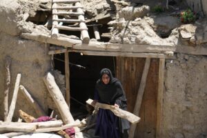 Afghan woman cleans up after an earthquake in Gayan village, in Paktika province, Afghanistan, Friday June 24, 2022. A powerful earthquake struck a rugged, mountainous region of eastern Afghanistan early Wednesday, flattening stone and mud-brick homes in the country’s deadliest quake in two decades, the state-run news agency reported. (AP Photo/Ebrahim Nooroozi)
