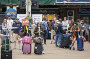 Passengers at Edinburgh’s Waverley Station during nationwide rail strikes, in Edinburgh, Saturday, June 25, 2022. Train stations are all but deserted across Britain on the third day of a national strike that snarled the weekend plans of millions. Train companies said only a fifth of passenger services would run on Saturday. (Jane Barlow/PA via AP)