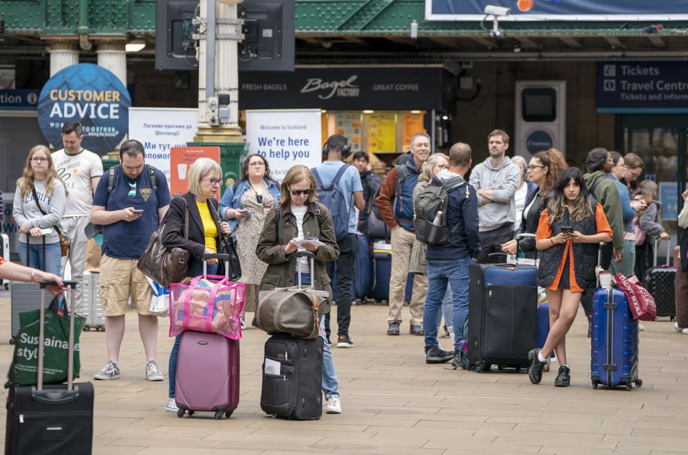 Passengers at Edinburgh’s Waverley Station during nationwide rail strikes, in Edinburgh, Saturday, June 25, 2022. Train stations are all but deserted across Britain on the third day of a national strike that snarled the weekend plans of millions. Train companies said only a fifth of passenger services would run on Saturday. (Jane Barlow/PA via AP)