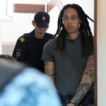 WNBA star and two-time Olympic gold medalist Brittney Griner is escorted to a courtroom for a hearing, in Khimki just outside Moscow, Russia, Monday, June 27, 2022. More than four months after she was arrested at a Moscow airport for cannabis possession, American basketball star Brittney Griner is to appear in court Monday for a preliminary hearing ahead of her trial. (AP Photo/Alexander Zemlianichenko)