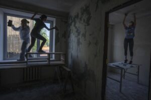 Women work to reconstruct a damaged fire department from Russian strikes, in Makariv, Kyiv region, Ukraine, Wednesday, June 29, 2022. Many buildings in Makariv were destroyed or partially damaged in the first weeks of the war. The youth volunteer movement ‘Building Ukraine Together,’ has since 2014 helped restore damaged buildings in eastern Ukraine. (AP Photo/Nariman El-Mofty)