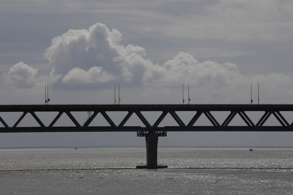 Bangladesh’s longest bridge, which took eight years to build amid setbacks involving political conflict and corruption allegations, stands over Padma River on the outskirts of Dhaka, Bangladesh, Saturday, June 25, 2022. The 6.51-kilometer (4.04-mile) bridge cost an estimated $3.6 billion and was paid for with domestic funds after the World Bank and other global lending agencies declined to finance the project following a graft scandal involving a Canadian construction company linked to the bridge. (AP Photo/Mahmud Hossain Opu)