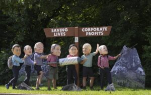 Activists from Oxfam wear giant heads of G7 leaders as they pose with a giant syringe during a demonstration in Munich, Germany, Saturday, June 25, 2022. The G7 Summit will take place at Castle Elmau near Garmisch-Partenkirchen from June 26 through June 28, 2022. Leaders depicted from left, French President Emmanuel Macron, Japan’s Prime Minister Fumio Kishida, U.S. President Joe Biden, Italy’s Prime Minister Mario Draghi, Canada’s Prime Minister Justin Trudeau, British Prime Minister Boris Johnson and German Chancellor Olaf Scholz. (AP Photo/Matthias Schrader)