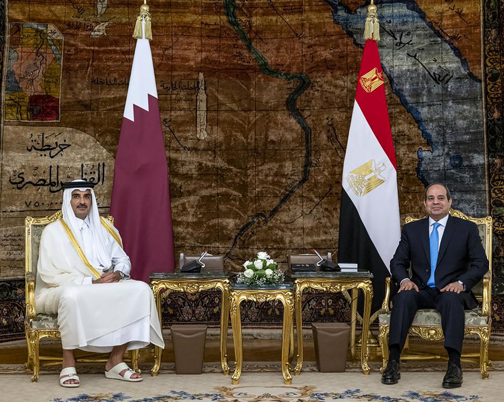 In this photo made available by Qatar News Agency, QNA, Qatari Emir Tamim bin Hamad Al Thani, meets with Egyptian President Abdel-Fattah el-Sissi, at the presidential palace in Cairo, Egypt, Saturday, June 25, 2022. Qatar’s emir arrived in Cairo to hold talks with Egypt’s president in his first visit since the two countries agreed to reset relations after more than seven years of diplomatic animosity. (QNA via AP)