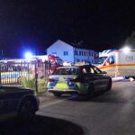 In this video still imgage police and emergency services stand at an asylum seeker shelter after a knife attack in Kressbronn, Germany, Sunday, June 26, 2022. A knife-wielding attacker has stabbed several people in a shelter for asylum-seekers in southern Germany, killing one man and wounding at least five people. (Davor Knappmeyer/dpa via AP)