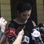 Karen Caballero, the mother of Fernando Redondo Caballero and Alejandro Andino Caballero who died near San Antonio, Texas, after being discovered in a hot trailer full of migrants being smuggled into the US, speaks during an impromptu conference at their home in Las Vegas, Honduras, Wednesday, June 29, 2022. Caballero’s sons were among the bodies of 51 people discovered in what is believed to be the nation’s deadliest smuggling episode on the U.S.-Mexico border. (AP Photo/Delmer Martinez)