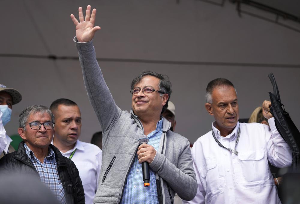 FILE – Then-Historical Pact coalition presidential candidate Gustavo Petro waves at supporters during a closing campaign rally in Zipaquira, Colombia, May 22, 2022. Petro, Colombia’s first elected leftist president, will take office in August with ambitious proposals to halt the record-high rates of deforestation in the Amazon. (AP Photo/Fernando Vergara, File)