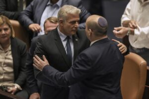 Israeli Prime Minister Naftali Bennett, right, and Foreign Minister Yair Lapid after a the vote on a bill to dissolve the parliament, at the Knesset, Israel’s parliament, in Jerusalem, Thursday, June 30, 2022. Israel’s parliament has voted to dissolve itself, sending the country to the polls for the fifth time in less than four years. (AP Photo/Ariel Schalit)