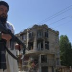 A Taliban fighter guards a Sikh temple following an attack by gunmen in Kabul on June 18, 2022.