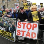 FILE – Demonstrators protest outside Hillsborough Castle, ahead of a visit by British Prime Minister Boris Johnson, in Hillsborough, Northern Ireland, Monday, May, 16, 2022. Britain is pressing on with a plan to rip up parts of the post-Brexit trade deal it signed with the bloc European Union. Legislation that rewrites trade rules for Northern Ireland is scheduled to get its first major House of Commons debate on Monday, June 27, 2022. (AP Photo/Peter Morrison, File)