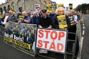 FILE – Demonstrators protest outside Hillsborough Castle, ahead of a visit by British Prime Minister Boris Johnson, in Hillsborough, Northern Ireland, Monday, May, 16, 2022. Britain is pressing on with a plan to rip up parts of the post-Brexit trade deal it signed with the bloc European Union. Legislation that rewrites trade rules for Northern Ireland is scheduled to get its first major House of Commons debate on Monday, June 27, 2022. (AP Photo/Peter Morrison, File)