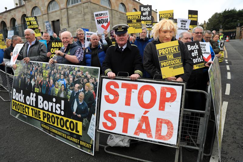 FILE – Demonstrators protest outside Hillsborough Castle, ahead of a visit by British Prime Minister Boris Johnson, in Hillsborough, Northern Ireland, Monday, May, 16, 2022. Britain is pressing on with a plan to rip up parts of the post-Brexit trade deal it signed with the bloc European Union. Legislation that rewrites trade rules for Northern Ireland is scheduled to get its first major House of Commons debate on Monday, June 27, 2022. (AP Photo/Peter Morrison, File)