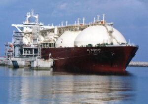 FILE – This undated file photo shows a Qatari liquid natural gas (LNG) tanker ship being loaded up with LNG, made up mainly of methane, at Raslaffans Sea Port, northern Qatar. The state-owned oil and gas company Qatar Energy said Monday, June 27, 2022, it is joining a new industry-led initiative to reduce nearly all methane emissions from operations by 2030. (AP Photo, File)