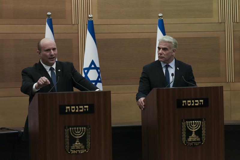 Israeli Prime Minister Naftali Bennett, left, speaks during a joint statement with Foreign Minister Yair Lapid, at the Knesset, Israel’s parliament, in Jerusalem, Monday, June 20, 2022. Bennett’s office announced Monday, that his weakened coalition will be disbanded and the country will head to new elections. Bennett and his main coalition partner, Yair Lapid, decided to present a vote to dissolve parliament in the coming days, Bennett’s office said. Lapid is then to serve as caretaker prime minister. The election, expected in the fall, would be Israel’s fifth in three years. (AP Photo/Maya Alleruzzo)