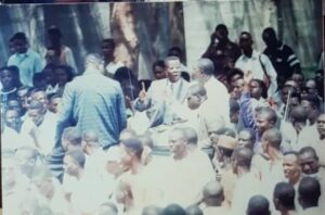 Igini on suit with his right forefinger raised during the June 12, 1993 struggle