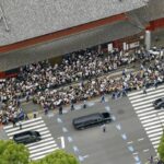 The hearse carrying former Prime Minister Shinzo Abe, leaves Zojoji temple after his funeral in Tokyo on Tuesday, July 12, 2022. Abe was assassinated Friday while campaigning in Nara, western Japan.(Kyodo News via AP)