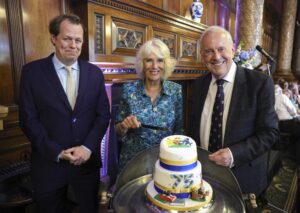 Tom Parker Bowles, left, Camilla, Duchess of Cornwall, and Gyles Brandreth, founder of Poetry Together, right, during The Oldie Luncheon, in celebration of Camilla’s 75th Birthday at National Liberal Club in London, Tuesday, July 12, 2022. (Chris Jackson/Pool via AP)
