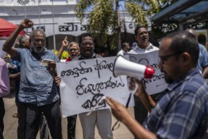 Trade union representatives and activists shout slogans during a protest against Sri Lanka’s acting president Ranil Wickremesinghe in Colombo, Sri Lanka, Monday, July 18, 2022. Wickremesinghe on Monday declared a state of emergency giving him broad authority amid growing protests demanding his resignation two days before the country’s lawmakers are set to elect a new president. (AP Photo/Rafiq Maqbool)