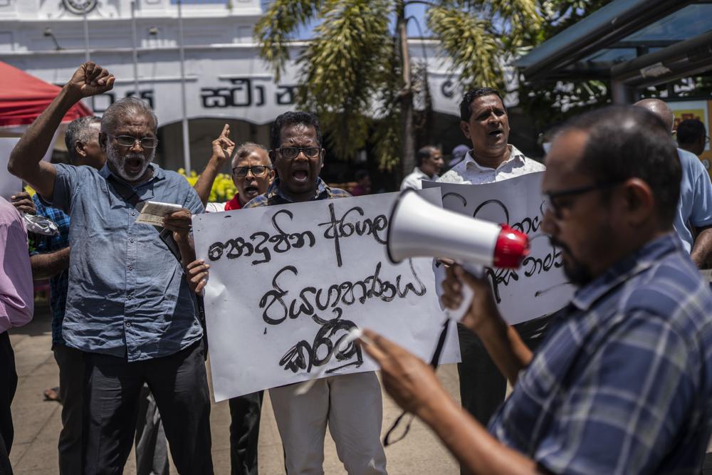 Trade union representatives and activists shout slogans during a protest against Sri Lanka’s acting president Ranil Wickremesinghe in Colombo, Sri Lanka, Monday, July 18, 2022. Wickremesinghe on Monday declared a state of emergency giving him broad authority amid growing protests demanding his resignation two days before the country’s lawmakers are set to elect a new president. (AP Photo/Rafiq Maqbool)