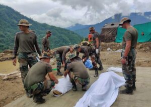 Soldiers wrap bodies of victims of a mudslide in Noney, northeastern Manipur state, India, Friday, July 1, 2022. Rescuers found more bodies Friday as they resumed searching for dozens of missing after a mudslide triggered by weeks of heavy downpours killed at least 19 people at a railroad construction site in India’s northeast, officials said. (AP Photo/Agui Kamei)