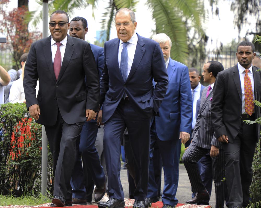 FILE – Russian Foreign Minister Sergey Lavrov, center, walks with Ethiopian Deputy Prime Minister Demeke Mekonnen, left, as they visit the compound of the Russian Embassy in Addis Ababa, Ethiopia, July 27, 2022. Russian, French and American leaders are crisscrossing Africa to win support for their positions on the war in Ukraine, an intense competition for influence the continent has not seen since the Cold War. (AP Photo, File)