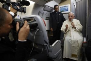 Pope Francis speaks to journalists aboard the papal flight back from Canada Saturday, July 30, 2022, where he paid a six-day pastoral visit. Pope Francis wrapped up his Canadian pilgrimage by meeting with Indigenous delegations and visiting Inuit territory in northern Nunavut. In one of his addresses, he assailed the Catholic missionaries who “supported oppressive and unjust policies” against Native peoples in the country’s notorious residential schools and vowed to pursue truth and healing. (Guglielmo Mangiapane/ Pool via AP)