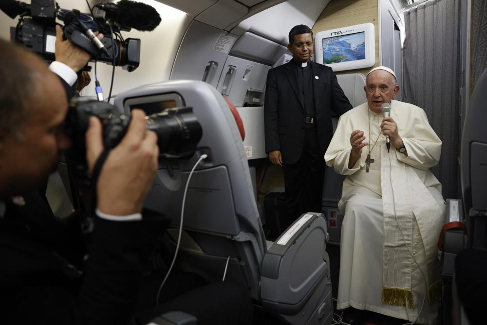 Pope Francis speaks to journalists aboard the papal flight back from Canada Saturday, July 30, 2022, where he paid a six-day pastoral visit. Pope Francis wrapped up his Canadian pilgrimage by meeting with Indigenous delegations and visiting Inuit territory in northern Nunavut. In one of his addresses, he assailed the Catholic missionaries who “supported oppressive and unjust policies” against Native peoples in the country’s notorious residential schools and vowed to pursue truth and healing. (Guglielmo Mangiapane/ Pool via AP)