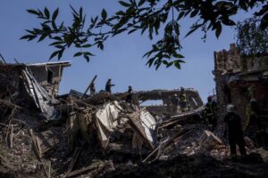 Rescue workers clearing rubble of destroyed house after a Russian attack on a residential neighborhood in downtown Kharkiv, Ukraine, on Saturday, July 9, 2022. (AP Photo/Evgeniy Maloletka)