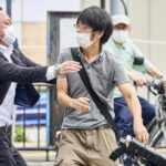 FILE – Tetsuya Yamagami, center, holding a weapon, is detained near the site of gunshots in Nara, western Japan, Friday, July 8, 2022. The 40-centimeter-long (16-inch) firearm that was used to kill former Prime Minister Shinzo Abe on Friday as he campaigned for his ruling party in Nara, western Japan, looked crude, more like a propellant made of pipes taped together and filled with explosives. (Nara Shimbun/Kyodo News via AP, File)