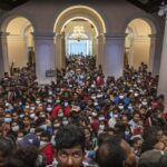 People throng President Gotabaya Rajapaksa’s official residence for the second day after it was stormed in Colombo, Sri Lanka, Monday, July 11, 2022. Sri Lanka is in a political vacuum for a second day Monday with opposition leaders yet to agree on who should replace its roundly rejected leaders, whose residences are occupied by protesters, angry over the country’s economic woes. (AP Photo/Rafiq Maqbool)