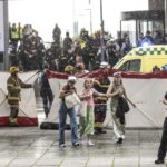People leave the Field’s shopping center in Copenhagen, Denmark Sunday, July 3, 2022. A gunman opened fire inside the busy shopping mall in the Danish capital Sunday, killing a few people and critically wounding a few others, police said. (Olafur Steinar Rye Gestsson/Ritzau Scanpix via AP)