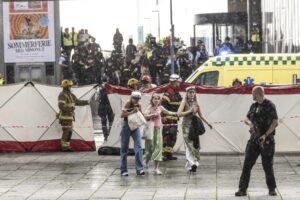 People leave the Field’s shopping center in Copenhagen, Denmark Sunday, July 3, 2022. A gunman opened fire inside the busy shopping mall in the Danish capital Sunday, killing a few people and critically wounding a few others, police said. (Olafur Steinar Rye Gestsson/Ritzau Scanpix via AP)