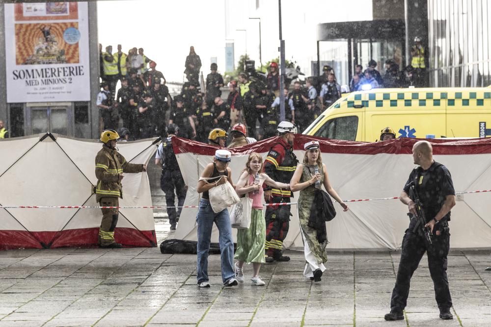 People leave the Field’s shopping center in Copenhagen, Denmark Sunday, July 3, 2022. A gunman opened fire inside the busy shopping mall in the Danish capital Sunday, killing a few people and critically wounding a few others, police said. (Olafur Steinar Rye Gestsson/Ritzau Scanpix via AP)