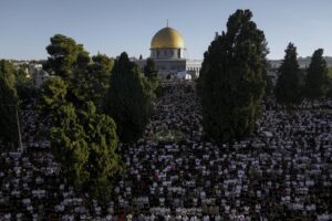 Muslim worshipers offer Eid al-Adha prayers next to the Dome of the Rock shrine at the Al Aqsa Mosque compound in Jerusalem’s Old City, Saturday, July 9, 2022. The major Muslim holiday, at the end of the hajj pilgrimage to Mecca, is observed around the world by believers and commemorates prophet Abraham’s pledge to sacrifice his son as an act of obedience to God. (AP Photo/Mahmoud Illean)