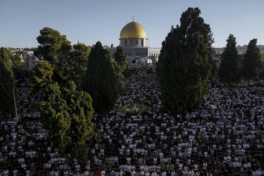 Muslim worshipers offer Eid al-Adha prayers next to the Dome of the Rock shrine at the Al Aqsa Mosque compound in Jerusalem’s Old City, Saturday, July 9, 2022. The major Muslim holiday, at the end of the hajj pilgrimage to Mecca, is observed around the world by believers and commemorates prophet Abraham’s pledge to sacrifice his son as an act of obedience to God. (AP Photo/Mahmoud Illean)