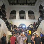 Protesters storm in at the Sri Lankan president’s official residence, in Colombo, Sri Lanka , Saturday, July, 9, 2022. Protesters have broken into the Sri Lankan prime minister’s private residence and set it on fire, hours after he said he would resign when a new government is formed over a worsening economic crisis. It was the biggest day of demonstrations that also saw crowds storming the president’s home and office. (AP Photo/ Eranga Jayawardena)