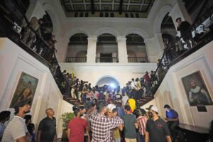Protesters storm in at the Sri Lankan president’s official residence, in Colombo, Sri Lanka , Saturday, July, 9, 2022. Protesters have broken into the Sri Lankan prime minister’s private residence and set it on fire, hours after he said he would resign when a new government is formed over a worsening economic crisis. It was the biggest day of demonstrations that also saw crowds storming the president’s home and office. (AP Photo/ Eranga Jayawardena)