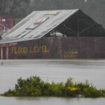 Flood waters surround an industrial property in Londonderry on the outskirts of Sydney, Australia, Monday, July 4, 2022. More than 30,000 residents of Sydney and its surrounds have been told to evacuate or prepare to abandon their homes on Monday as Australia’s largest city braces for what could be its worst flooding in 18 months. (AP Photo/Mark Baker)