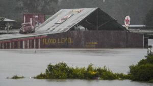 Flood waters surround an industrial property in Londonderry on the outskirts of Sydney, Australia, Monday, July 4, 2022. More than 30,000 residents of Sydney and its surrounds have been told to evacuate or prepare to abandon their homes on Monday as Australia’s largest city braces for what could be its worst flooding in 18 months. (AP Photo/Mark Baker)