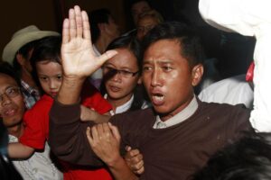 FILE – Kyaw Min Yu, a pro-democracy activist talks to journalists as he arrives at Yangon airport welcomed by his wife Nilar Thein, background, also an activist and his daughter after being released from a prison on Jan. 13, 2012, in Yangon. Myanmar has carried out its first executions in nearly 50 years. Kyaw Min Yu, a 53-year-old democracy activist better known as Ko Jimmy, was executed for violating the counterterrorism law. (AP Photo/File)