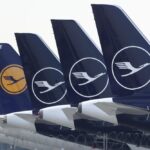 FILE –German Lufthansa planes sit parked in a line at the airport in Munich, Germany, Thursday, March 26, 2020. Lufthansa says it will have to cancel almost all flights at its main Frankfurt and Munich hubs on Wednesday because of a strike by its German ground staff. (AP Photo/Matthias Schrader),file)