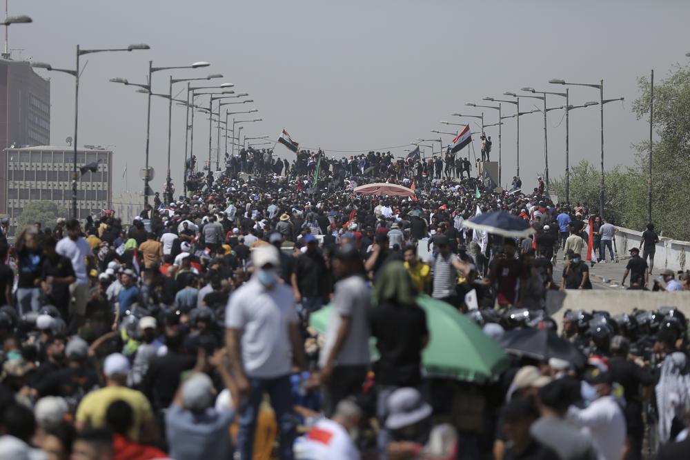 Protesters gather a bridge leading to the Green Zone area in Baghdad, Iraq, Saturday, July 30, 2022 — days after hundreds breached Baghdad’s parliament Wednesday chanting anti-Iran curses in a demonstration against a nominee for prime minister by Iran-backed parties.(AP Photo/Anmar Khalil)