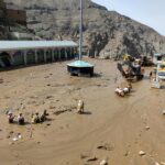 In this photo provided by the Iranian Red Crescent Society, members of a rescue team work at the site of a flash flood in the northwestern part of Tehran, Iran, Thursday, July 28, 2022. Heavy rains in the early hours of Thursday caused flash floods and then landslides and caused damage to Imamzadeh Davood, a religious shrine in the city. (Iranian Red Crescent Society via AP)