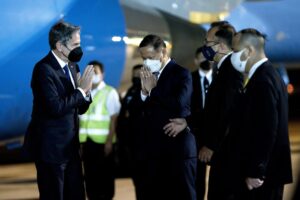 US Secretary of State Antony Blinken is greeted by Michael Health, Charge d’ Affaires a.i. of the US Mission in Thailand, and Chettaphan Maksamphan, MFA DG American and South Pacific Affairs, upon his arrival at Bangkok Don Mueang International Airport in Bangkok, Thailand, Saturday, July 9, 2022. (Stefani Reynolds, Pool Photo via AP)