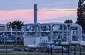 The sun rises behind the pipe systems and shut-off devices at the gas receiving station of the Nord Stream 1 Baltic Sea pipeline and the transfer station of the OPAL gas pipeline, Baltic Sea Pipeline Link, in Lubmin, Germany, Monday, July 11, 2022. The Nord Stream 1 pipeline, Germany’s main source of Russian gas, is scheduled to be out of action until July 21, 2022, for routine work. The operator said the gas flow was reduced progressively starting at 6 a.m. ( Jens Buettner/dpa via AP)