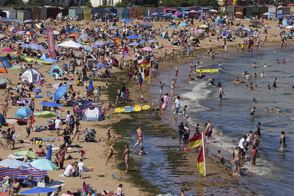 Crowds enjoy the hot weather at the beach as temperatures continue to climb, in Broadstairs, Kent, England, Saturday July 16, 2022. PA Photo. (Gareth Fuller/PA via AP)