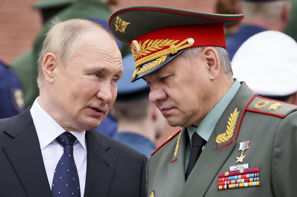 FILE – Russian President Vladimir Putin speaks with Russian Defence Minister Sergei Shoigu during a wreath laying ceremony at the Tomb of Unknown Soldier in Moscow, Russia, Wednesday, June 22, 2022, marking the 81st anniversary of the Nazi invasion of the Soviet Union. Defense Minister Sergei Shoigu told President Vladimir Putin that Russia’s troops together with members of a local separatist militia “have established full control over the city of Lysychansk,” a ministry statement said Sunday, July 3, 2022. (Mikhail Metzel, Sputnik, Kremlin Pool Photo via AP, File)